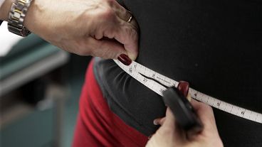 File picture of a person's waist being measured during an obesity prevention study 