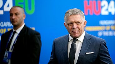 Slovakia's Prime Minister Robert Fico, right, arrives for an EU Summit at the Puskas Arena in Budapest, Hungary, Friday, Nov. 8, 2024.