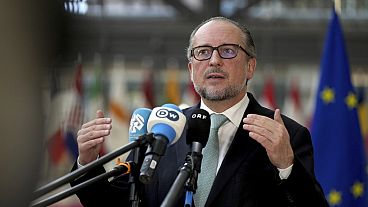 Austria's Foreign Minister Alexander Schallenberg speaks with the media as he arrives for a meeting of EU foreign ministers at the European Council building in Brussels, Monda