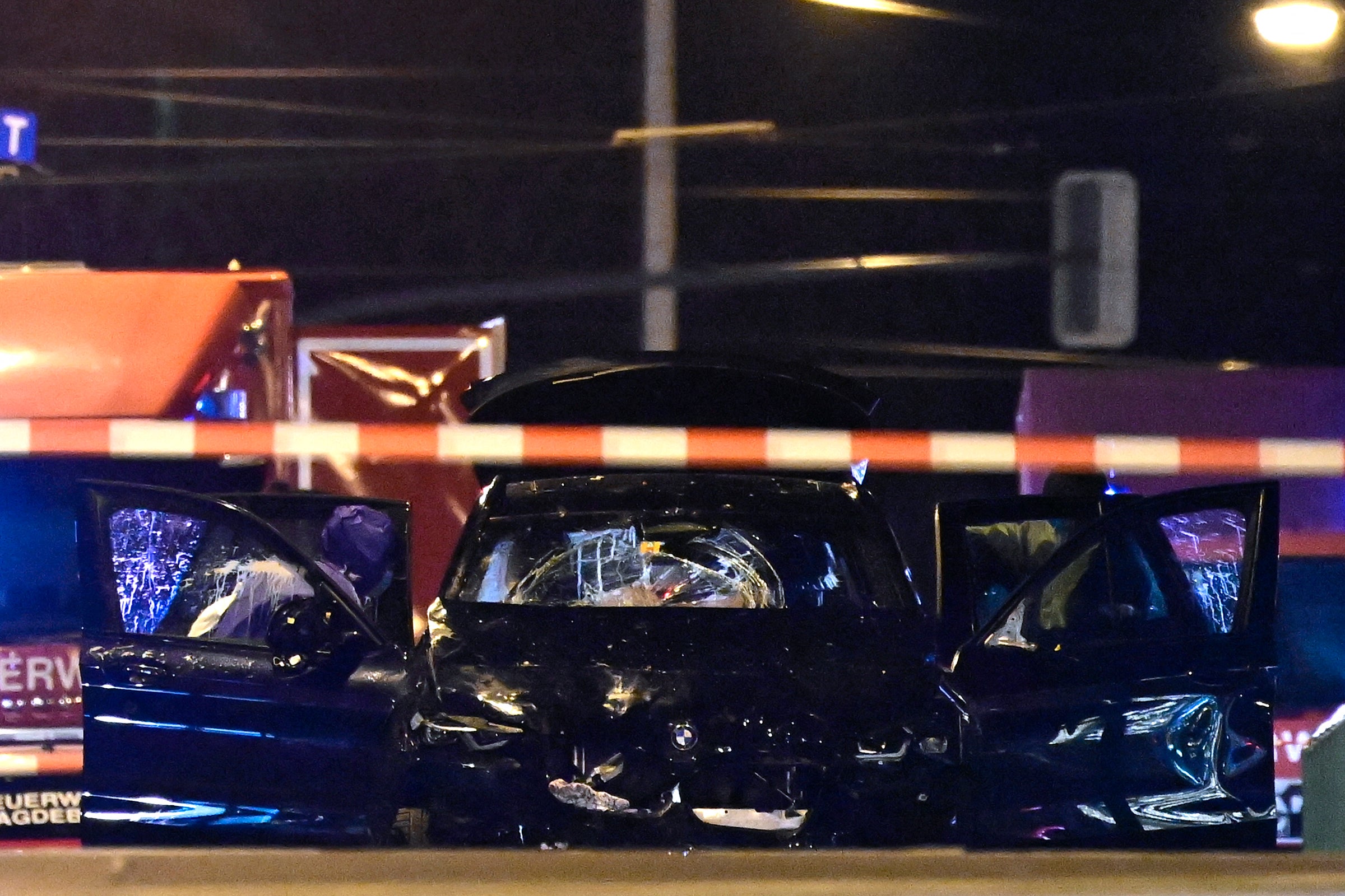 A smashed up car allegedly belonging to the suspect behind a police cordon