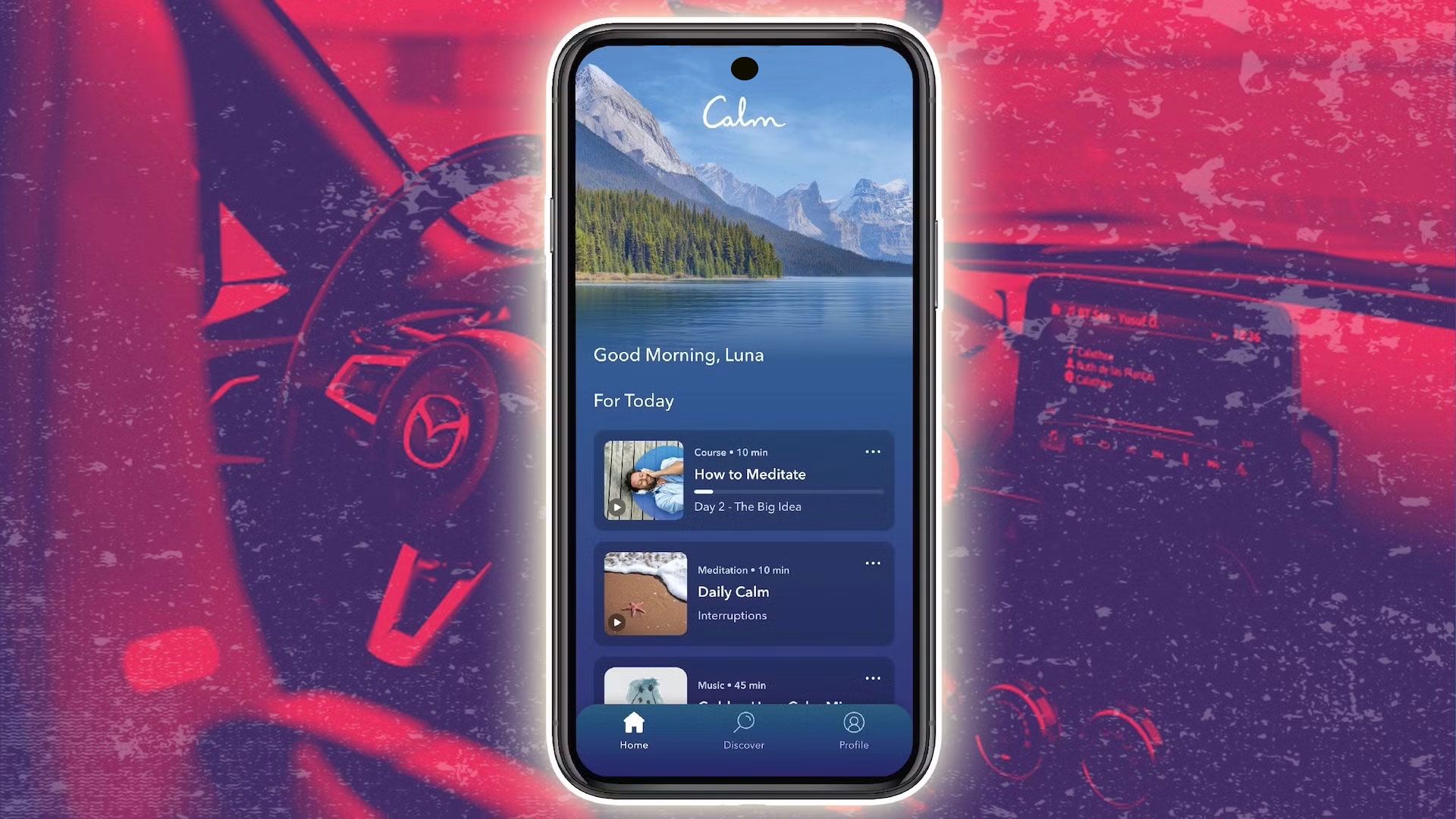 A smartphone with the Calm app sits atop a red background of a car interior
