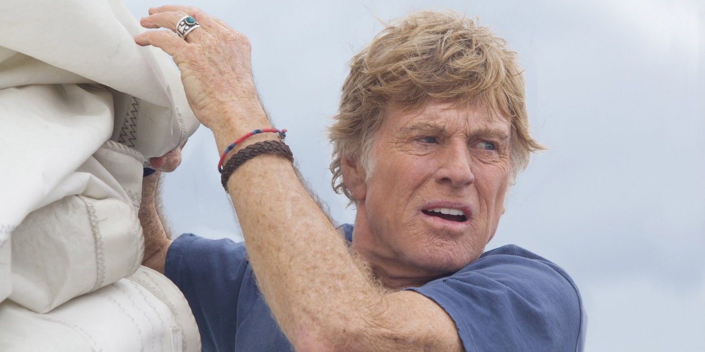 Robert Redford hanging off the side of a boat in All Is Lost