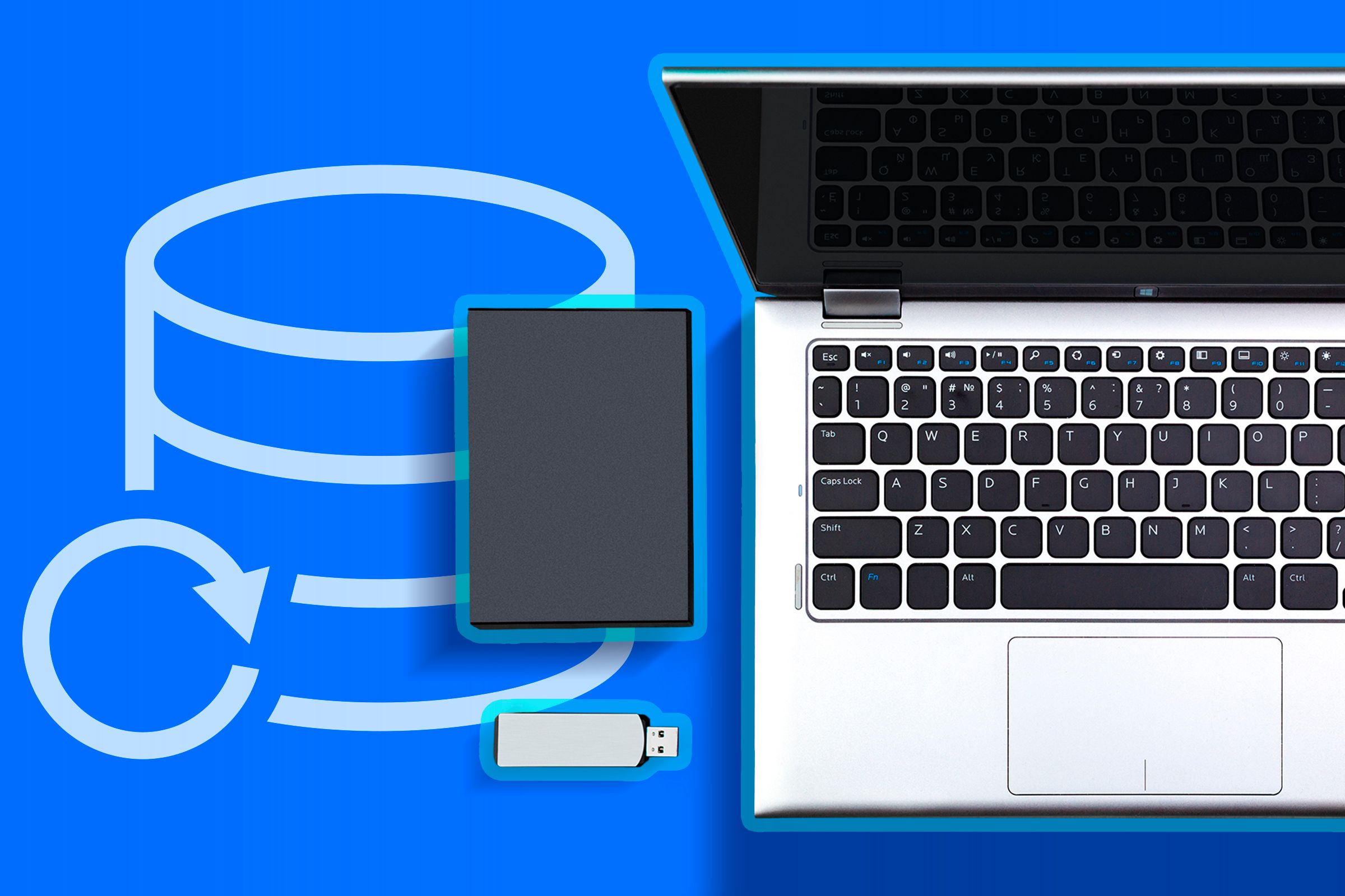 A laptop with a USB drive and an external hard drive next to it and a backup icon.