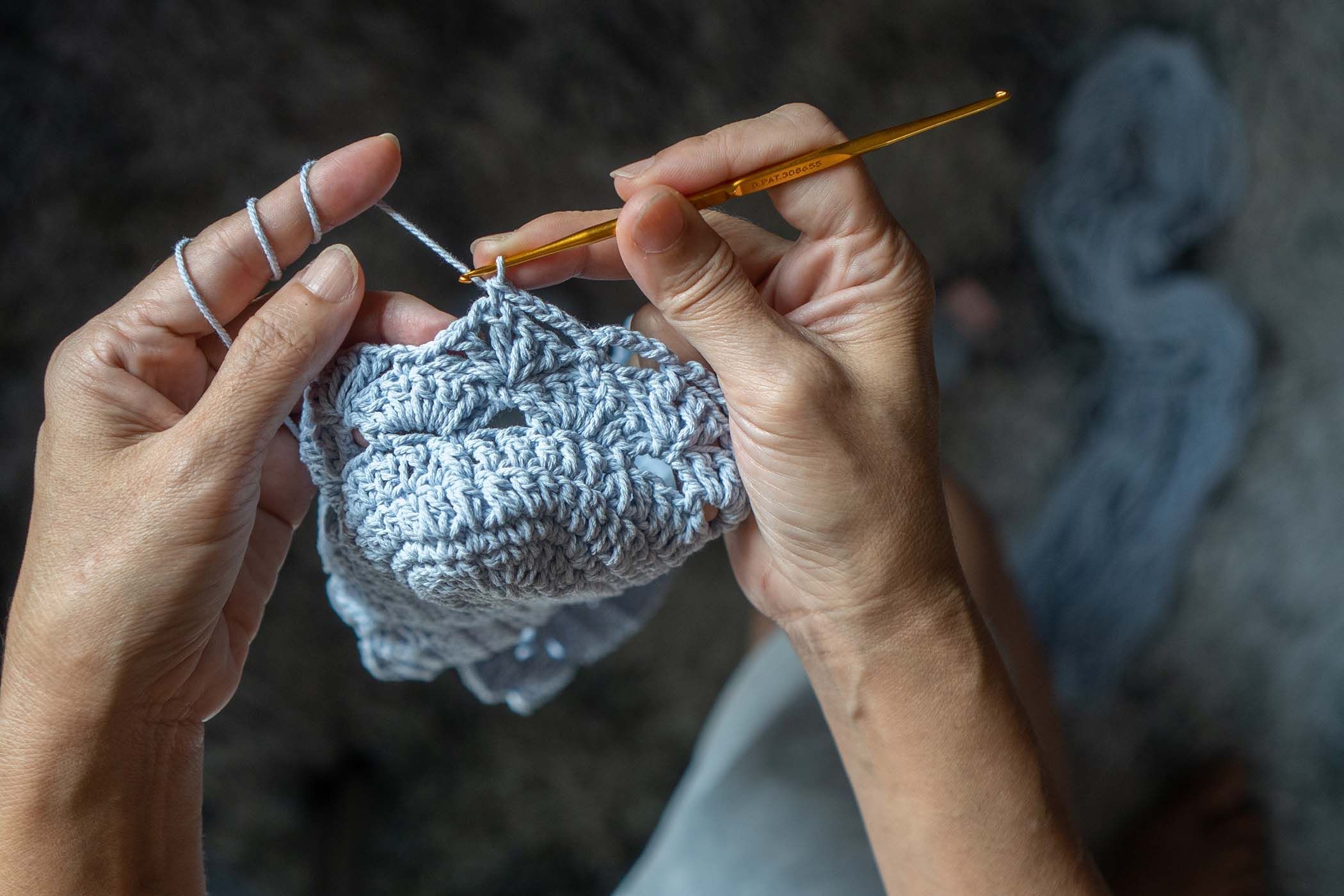 Hands crocheting a piece