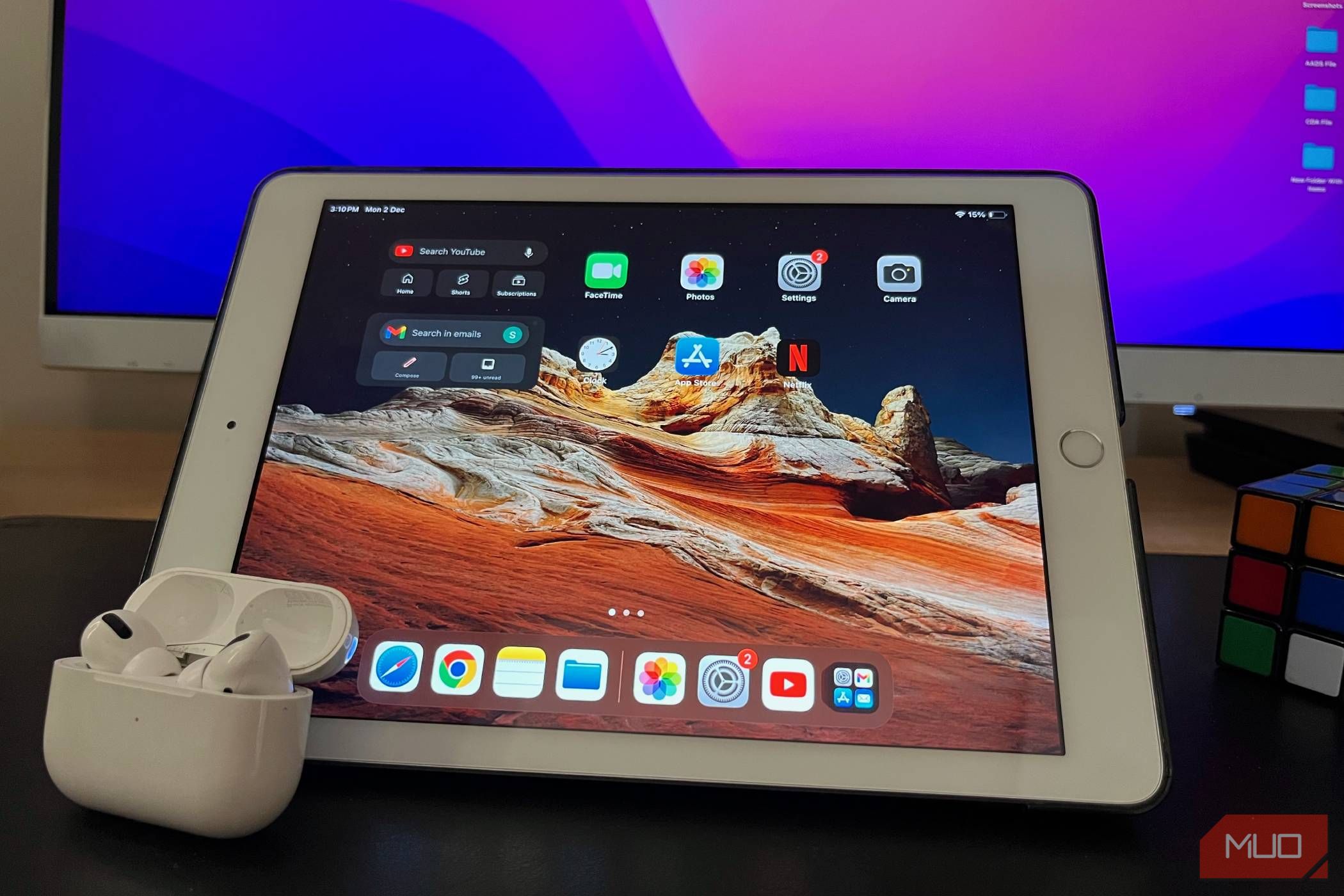 A 6th-generation iPad on a table with a pair of AirPods Pro placed on its screen.