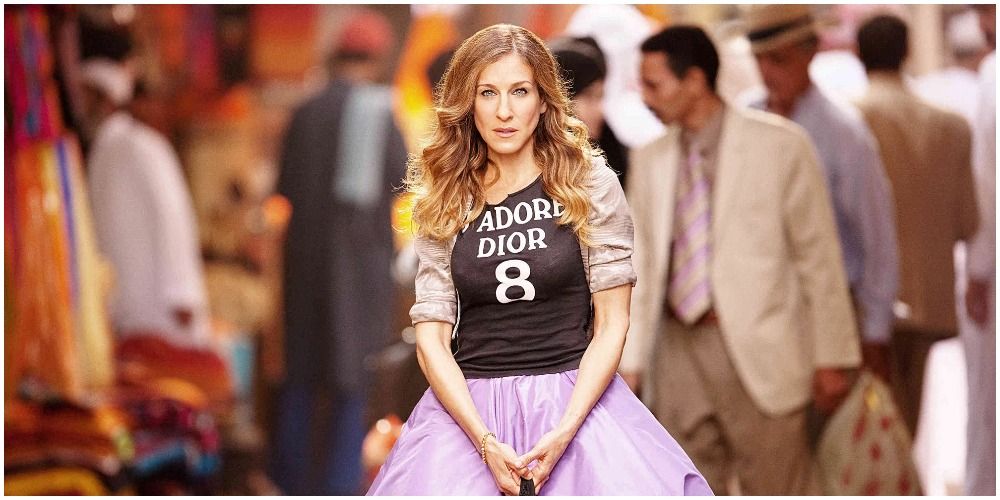 SATC - Carrie in the street with pink tutu skirt and Dior shirt. 