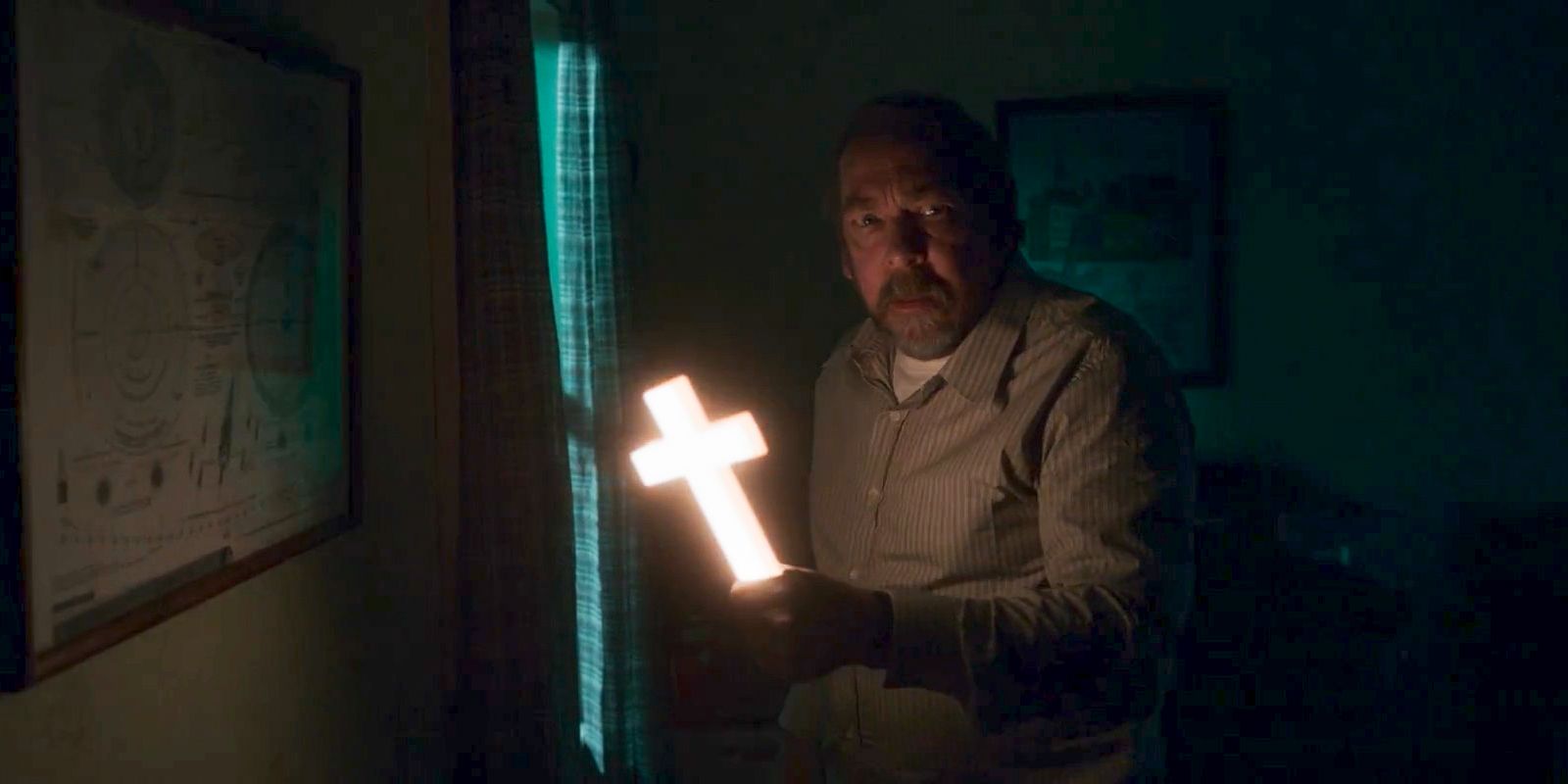 Matt Burke (Bill Camp) holding a shining cross in Salem's Lot (2024)