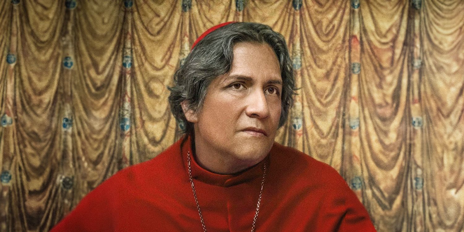 A cardinal in front of a gold backdrop in Conclave