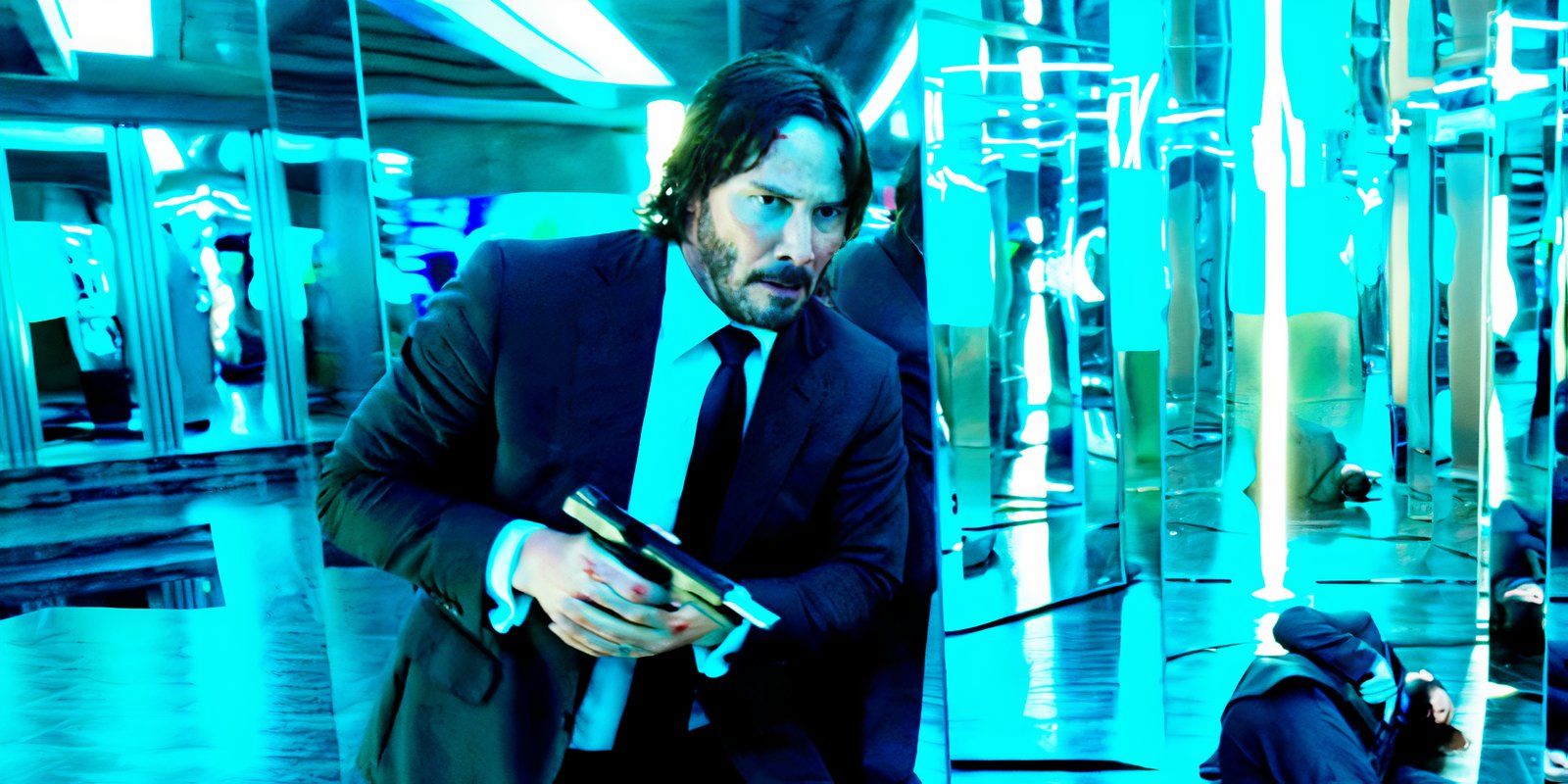 Keanu Reeves takes cover with a pistol in a hall of mirrors in John Wick Chapter 2