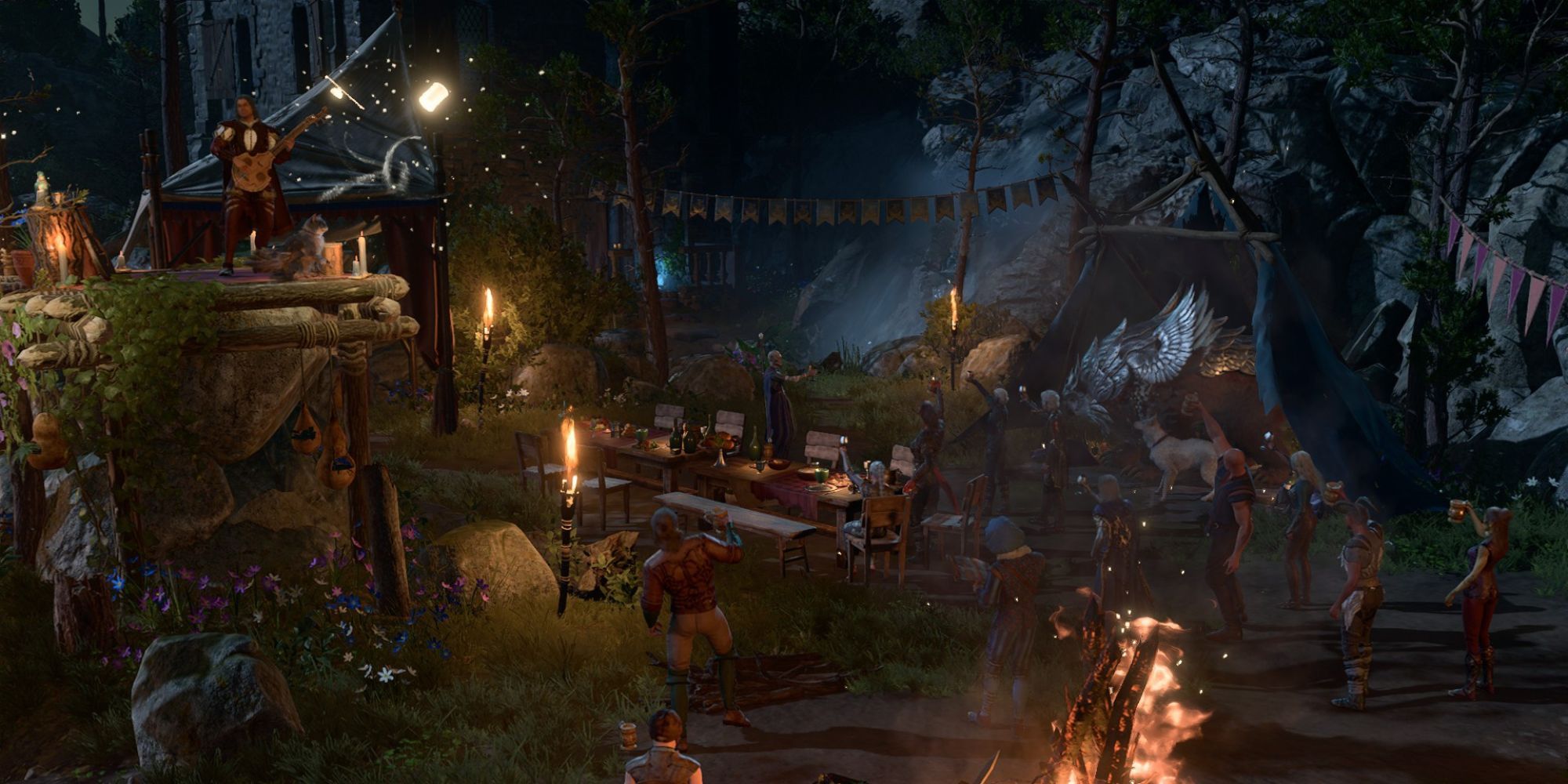 The Wilderness camp in Baldur's Gate 3 decked out with decorations, food, drinks, a bonfire, and a long table. 