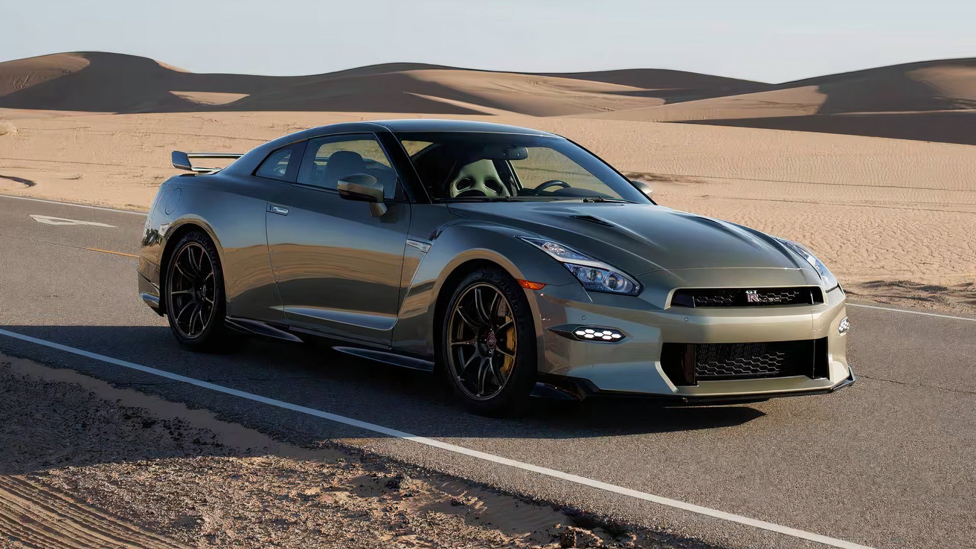 2024 Nissan GT-R T-Spec in green driving on desert road