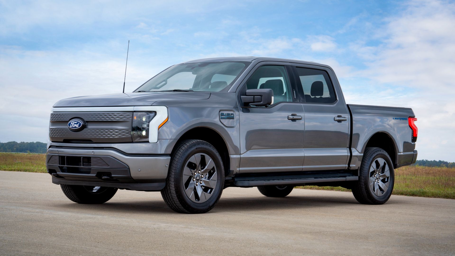 Font three-quarter photo of 2024 Ford F-150 Flash electric pickup truck in gray