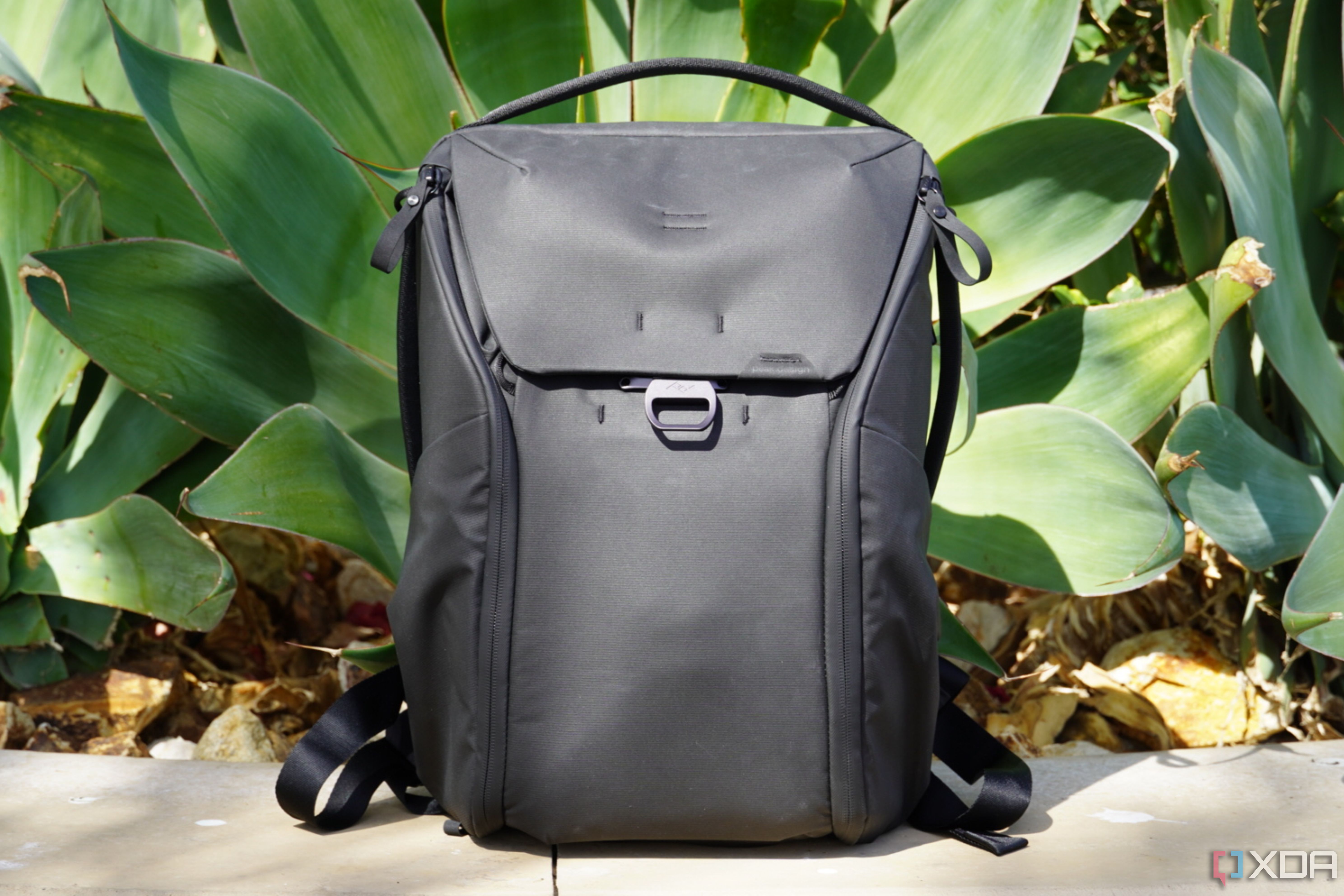 The Peak Design Everyday Backpack in front of plants.