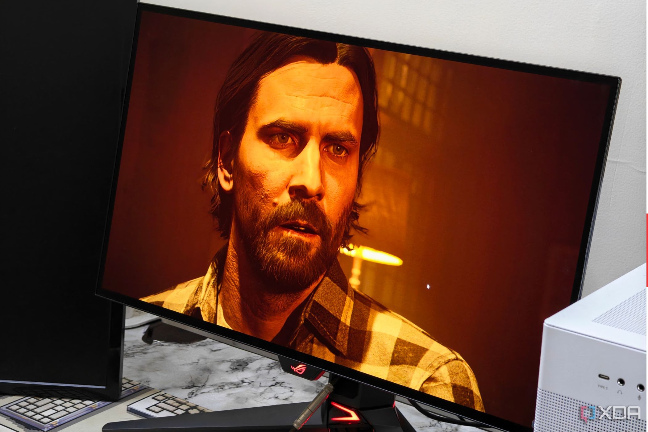 An image showing the Asus ROG Swift PG27AQDM monitor displaying a screenshot from Alan Wake 2 game.