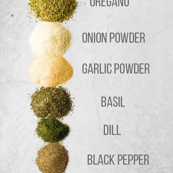 ingredients to make greek seasoning blend with labels on white background