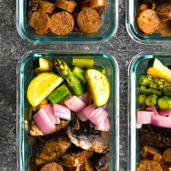 overhead shot of four glass meal prep containers with low carb breakfast bowls