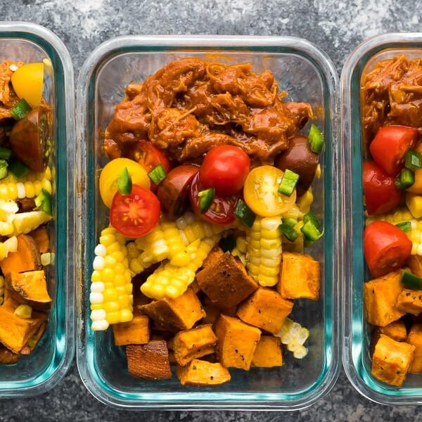 overhead shot of pulled pork meal prep bowls in glass containers