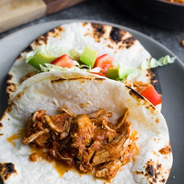 gray plate with salsa chicken in fajitas