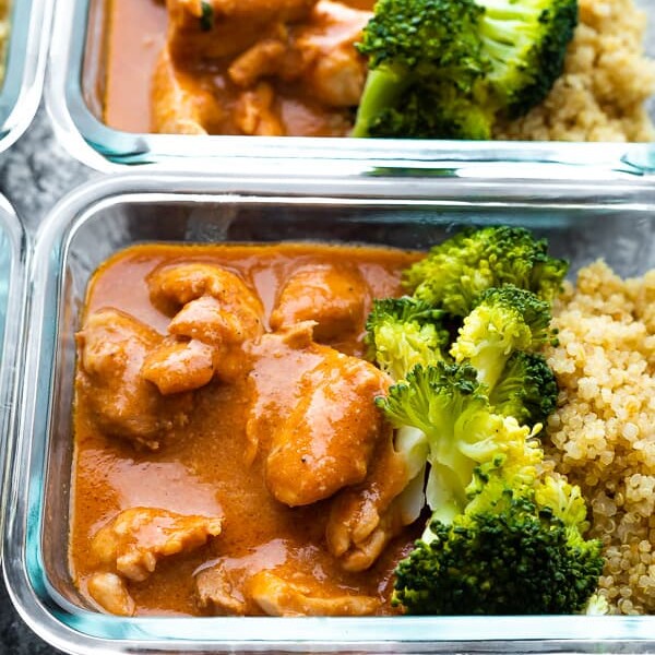 glass meal prep container filled with slow cooker butter chicken and broccoli