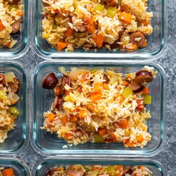 overhead shot of instant pot cajun rice and sausage in multiple glass meal prep containers