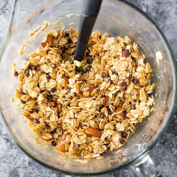 ingredients for homemade no bake granola bars in glass mixing bowl from overhead