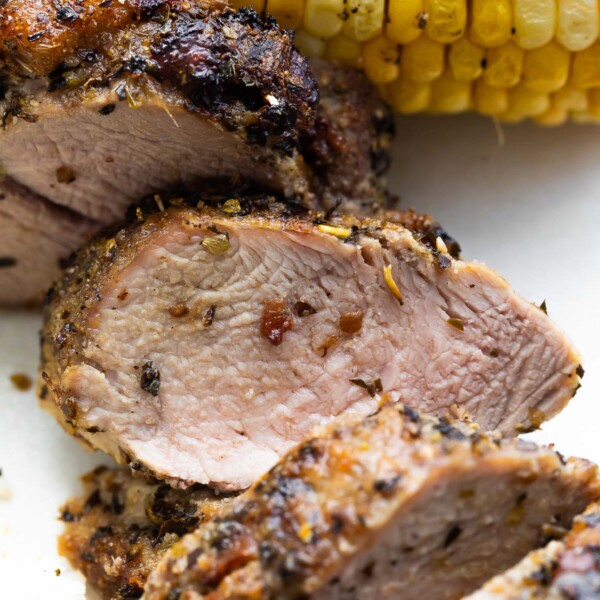 close up shot of sliced pork tenderloin on plate showing the juicy interior