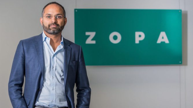 Jaidev Janardana of Zopa next to a logo