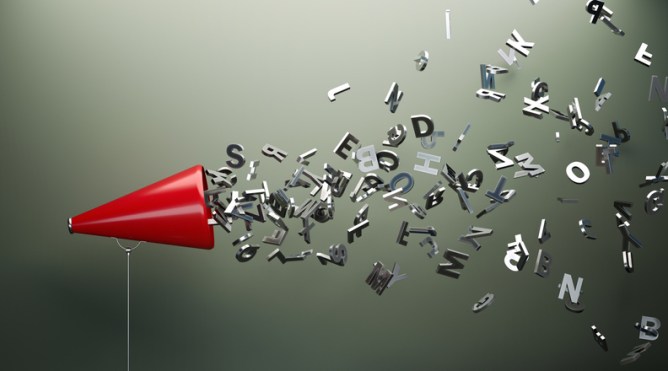 Red megaphone and silver colored alphabet letters in front of gray wall. Horizontal composition with copy space. Great use for announcement concepts.