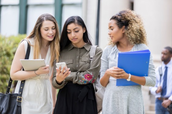 College students reading text on smartphone