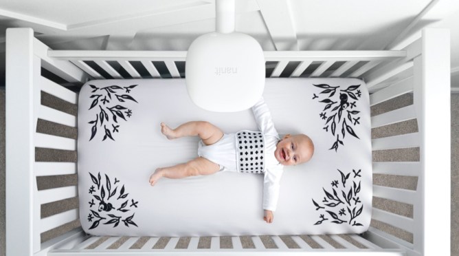 baby laying in a crib, overhead view