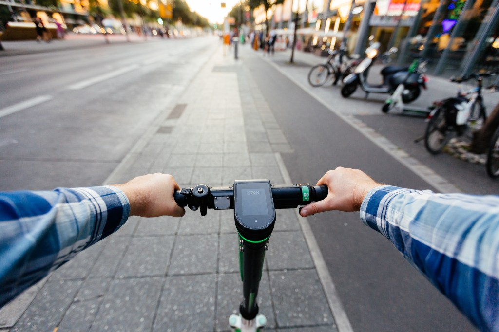 First person view of riding an e-scooter in a city