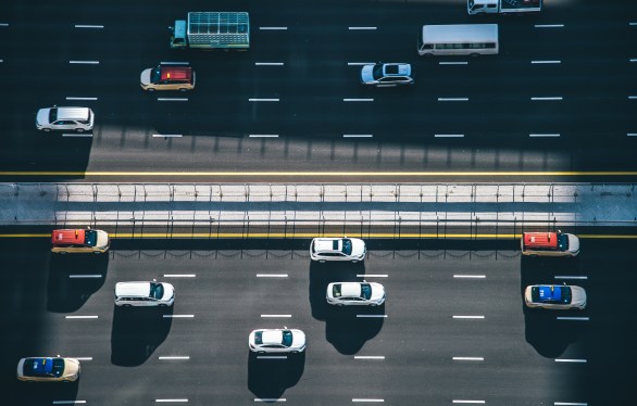 Drone point of view of vehicles on a busy highway.