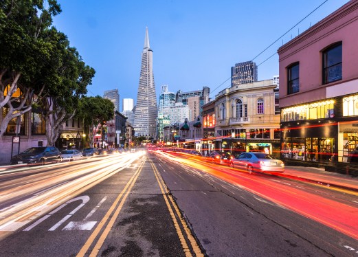 Traffic, captured with blurred motion, rush along Columbus avenue in North Beach in San Francisco at night. The avenue leads to the financial district. (Traffic, captured with blurred motion, rush along Columbus avenue in North Beach in San Francisco