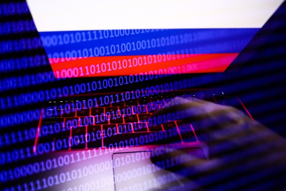 Russian flag displayed on a laptop screen and binary code code displayed on a screen are seen in this multiple exposure illustration photo