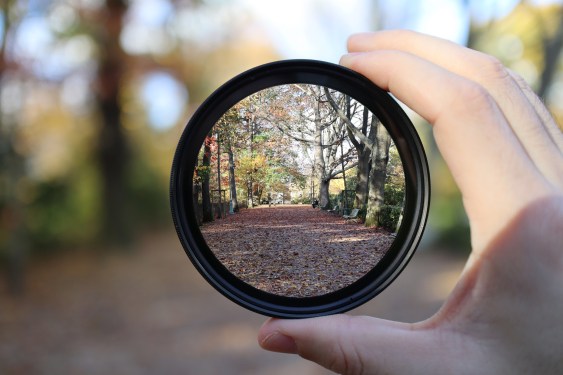 hand holding magnifying glass to provide a clear view