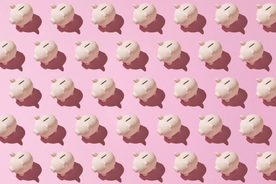 Little pink ceramic piggy bank pattern on pink background. Concept of saving money, savings.