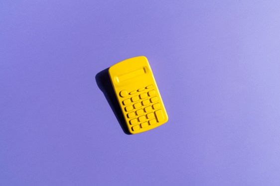 Yellow Calculator On Purple Background; financial model to forecast fundraising