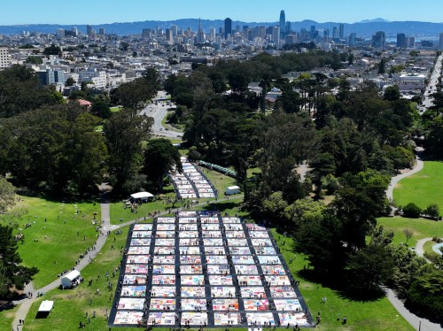 In an aerial view, over 3,000 panels of the AIDS Memorial Quilt are displayed on the lawn at Robin Williams Meadow in Golden Gate Park on June 11, 2022 in San Francisco, California. The National AIDS Memorial is marking the 35th anniversary of the AIDS Memorial Quilt with more than 3,000 panels of the Quilt being displayed in Golden Gate Park. It is the largest display of the Quilt in San Francisco history.