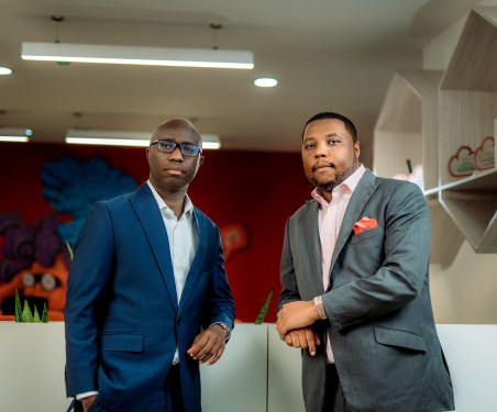 two men standing in office