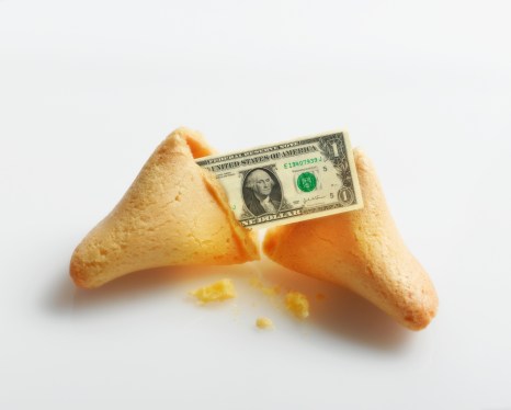 Broken fortune cookie with US Dollar inside