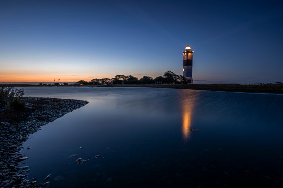 Illuminated lighthouse at dusk, Oland, Sweden