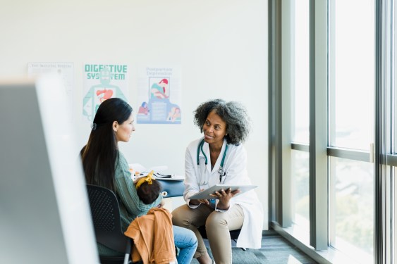 Female doctor and patient discuss treatment options