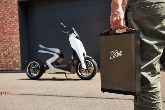 Zapp Electric vehicles i300 scooter view from the side with man's hand carrying removable battery pack