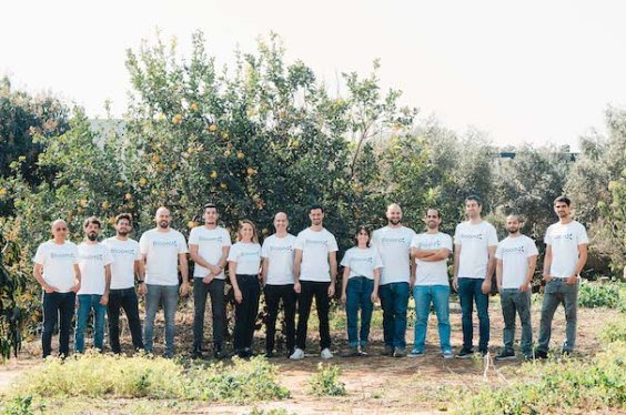 BloomX team standing in an orchard