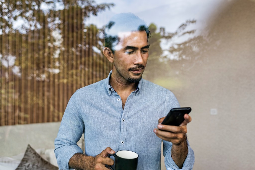 Man on smartphone in Jakarta, Indonesia, used in post about Kredivo