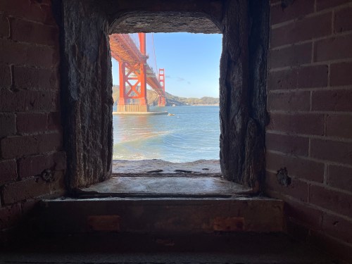 A view of the Golden Gate Bridge via a cannon portal at Fort Point.