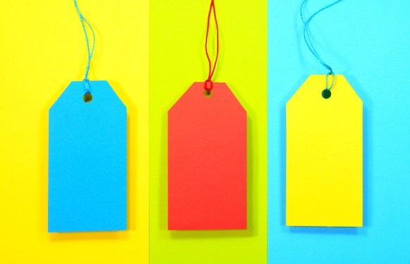 Blue, red and yellow sale tags on multicolored background