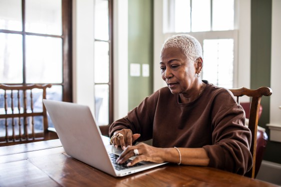 Woman using laptop at cafe table, used in post about cybersecurity startup SquareX