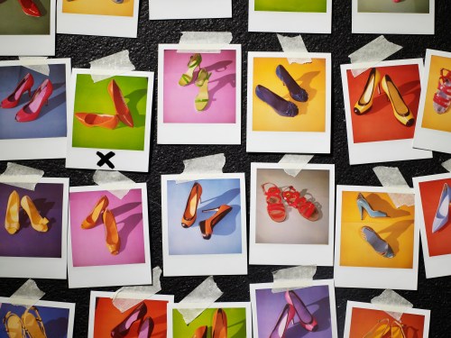 Polaroids of shoes taped to wall