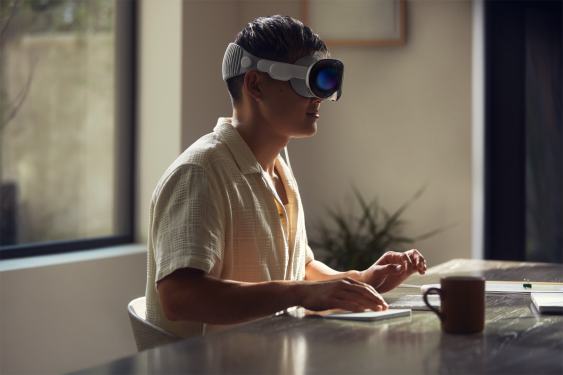 man sitting at desk wearing AR headset